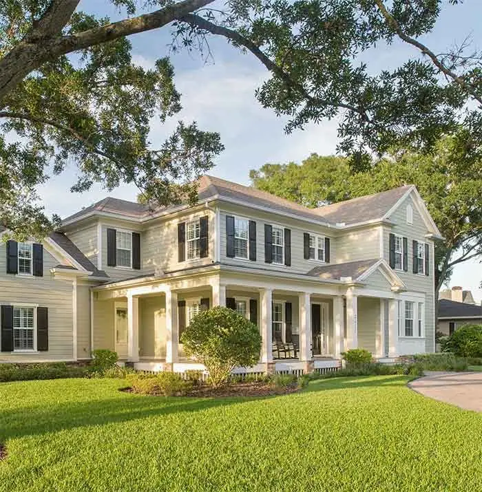 Two-story home with a front lawn in Odessa, Florida